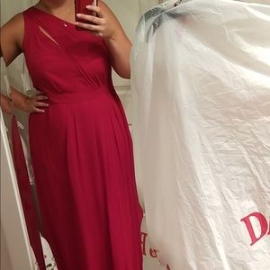 Red David’s bridal long dress with leg slit.